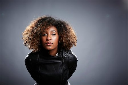 portraits proud - Portrait of young woman leaning into camera Stock Photo - Premium Royalty-Free, Code: 614-08066077