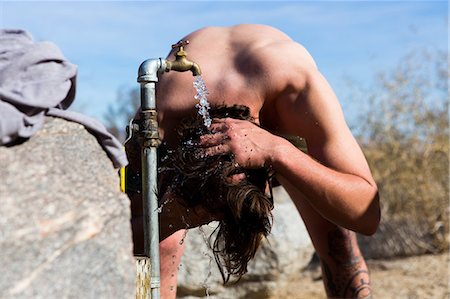 simsearch:614-08081221,k - Young man washing hair under campsite tap, Anza-Borrego Desert State Park, California, USA Stock Photo - Premium Royalty-Free, Code: 614-08081221