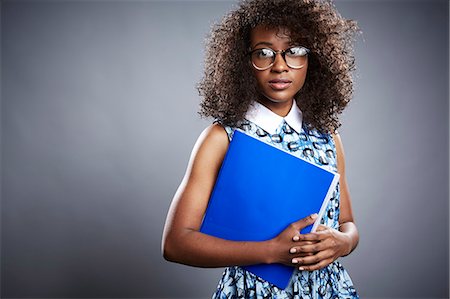 smart woman eyeglasses one person - Studio portrait of young female student with notebook Stock Photo - Premium Royalty-Free, Code: 614-08081378
