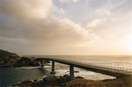 Silhouetted bridge on coastline, Reine, Lofoten, Norway Stock Photo - Premium Royalty-Free, Code: 614-08119459