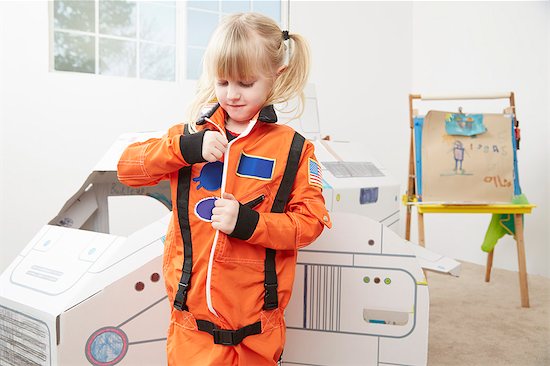 Young girl playing dress up, wearing astronaut outfit Stock Photo - Premium Royalty-Free, Image code: 614-08119489