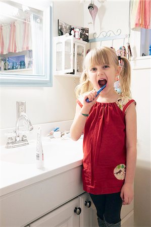 Portrait of young girl brushing teeth Stock Photo - Premium Royalty-Free, Code: 614-08119495