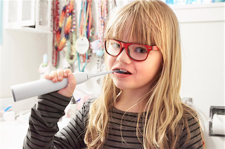 Portrait of young girl brushing teeth Stock Photo - Premium Royalty-Free, Code: 614-08119497