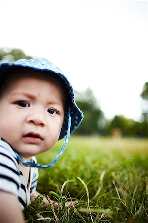 Close up portrait of baby boy looking at camera Stock Photo - Premium Royalty-Free, Code: 614-08119530