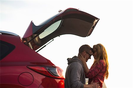 roadtrip vacation - Couple relaxing behind vehicle Stock Photo - Premium Royalty-Free, Code: 614-08119595