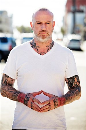 Mature man with tattoos on arms and neck Stock Photo - Premium Royalty-Free, Code: 614-08119625