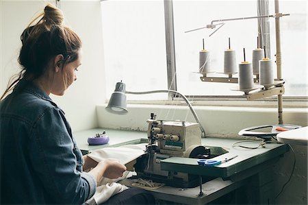 simsearch:695-05777791,k - Young female seamstress sewing textile on sewing machine Stock Photo - Premium Royalty-Free, Code: 614-08119662