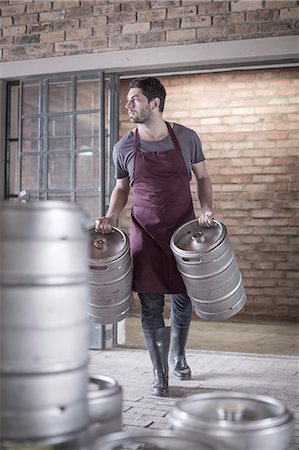 storage containers - Brewer carrying two kegs of beer Stock Photo - Premium Royalty-Free, Code: 614-08119913