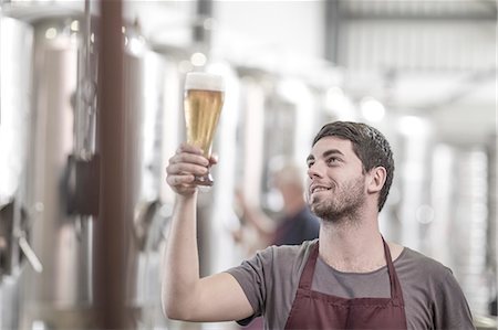 simsearch:614-08119905,k - Brewer in brewery holding up a glass of beer Fotografie stock - Premium Royalty-Free, Codice: 614-08119928