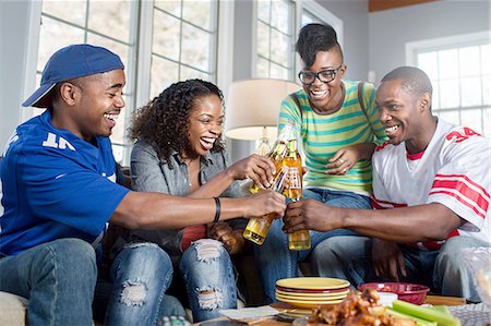 simsearch:614-05662131,k - Four adult friends toasting with bottled beer on living room sofa Stock Photo - Premium Royalty-Free, Code: 614-08126615