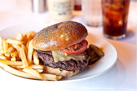 simple meal - Cheese burger and french fries on restaurant table Photographie de stock - Premium Libres de Droits, Code: 614-08126644