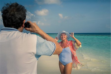 female woman swimsuit adult - Man photographing senior woman, Maldives Stock Photo - Premium Royalty-Free, Code: 614-08126826