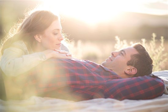 Young couple lying outdoors on blanket relaxing Stock Photo - Premium Royalty-Free, Image code: 614-08120054