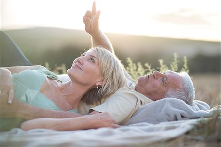 person lying about their age - Mature couple lying on blanket looking up Stock Photo - Premium Royalty-Free, Code: 614-08120050