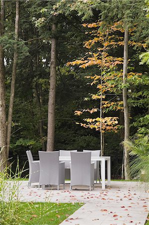 Flagstone path leading to table and chairs in landscaped backyard in autumn, Quebec, Canada Stock Photo - Premium Royalty-Free, Code: 614-08148367