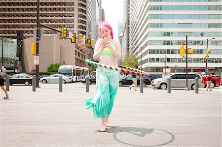 people reading city - Young woman hoola hooping whilst reading smartphone text, Philadelphia, Pennsylvania, USA Stock Photo - Premium Royalty-Free, Code: 614-08148494
