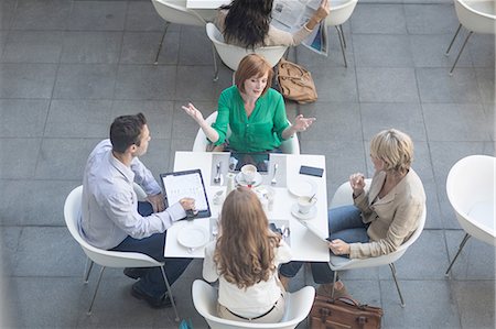 from above technology - High angle view of businessmen and businesswomen having lunch meeting on hotel terrace Stock Photo - Premium Royalty-Free, Code: 614-08148532