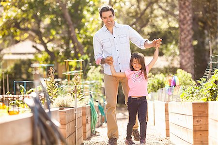 simsearch:614-08148597,k - Mid adult man holding hands with daughter in community garden Photographie de stock - Premium Libres de Droits, Code: 614-08148608