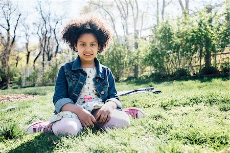 Front view of girl sitting on grass, looking at camera Stock Photo - Premium Royalty-Free, Code: 614-08201848