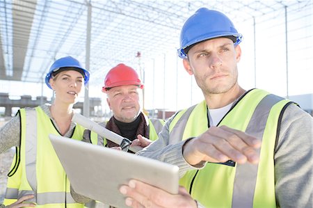 Surveyor and architects using digital tablet on construction site Stock Photo - Premium Royalty-Free, Code: 614-08202150