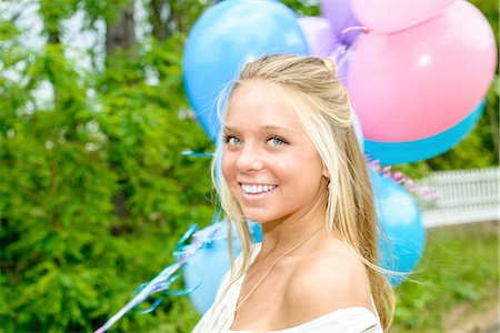 simsearch:614-08119768,k - Portrait of pretty young woman with long blond hair holding bunch of balloons Stock Photo - Premium Royalty-Free, Code: 614-08202310