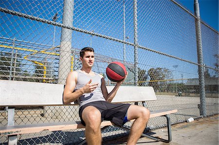 simsearch:649-07520889,k - Young male basketball player taking a break on bench Fotografie stock - Premium Royalty-Free, Codice: 614-08202333