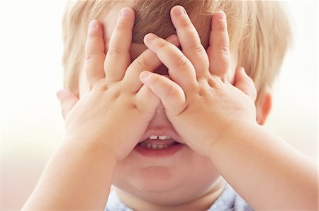 simsearch:632-05845347,k - Cropped portrait of young boy covering his eyes with his hands Stock Photo - Premium Royalty-Free, Code: 614-08220010