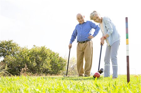 Senior couple playing croquet in park Stock Photo - Premium Royalty-Free, Code: 614-08220045