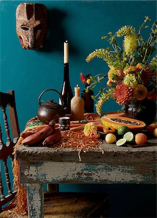 simsearch:649-08479771,k - Still life Mexican Day of the Dead rustic  Dutch masters theme with red bananas, apricot, lime and papaya Photographie de stock - Premium Libres de Droits, Code: 614-08270084