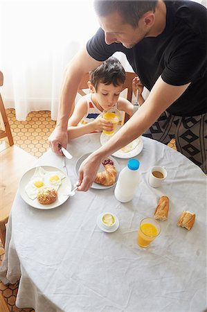 people eating eggs - Father and son having breakfast Stock Photo - Premium Royalty-Free, Code: 614-08270427