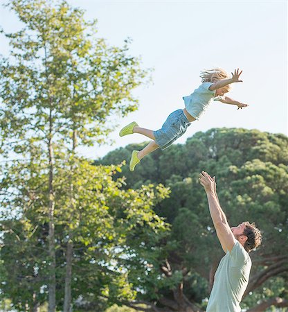 father and son playing catch - Father throwing son in air, outdoors Stock Photo - Premium Royalty-Free, Code: 614-08307579