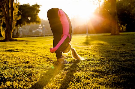 Woman stretching in park Stock Photo - Premium Royalty-Free, Code: 614-08307678