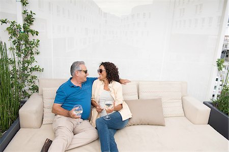 simsearch:614-03763782,k - Senior man and wife sitting on patio sofa Stock Photo - Premium Royalty-Free, Code: 614-08307717