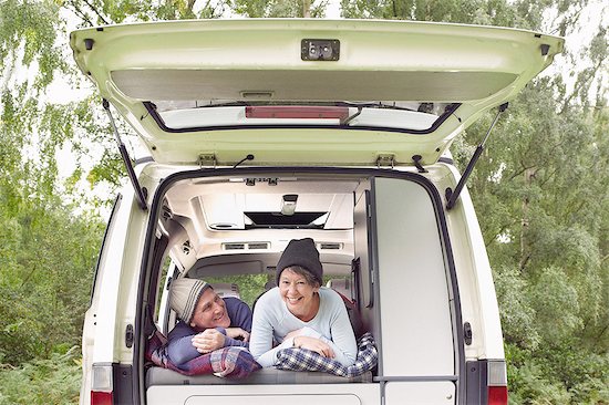 Senior couple lying inside open camper van Stock Photo - Premium Royalty-Free, Image code: 614-08307772