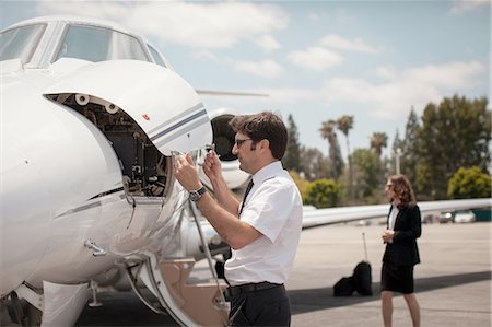 Male pilot checking private jet at airport Stock Photo - Premium Royalty-Free, Code: 614-08307849