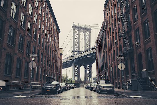 View of Brooklyn Bridge between industrial buildings, New York, USA Stock Photo - Premium Royalty-Free, Image code: 614-08307968