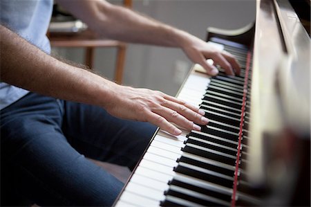 Cropped view of mature man sitting playing piano Stock Photo - Premium Royalty-Free, Code: 614-08308005