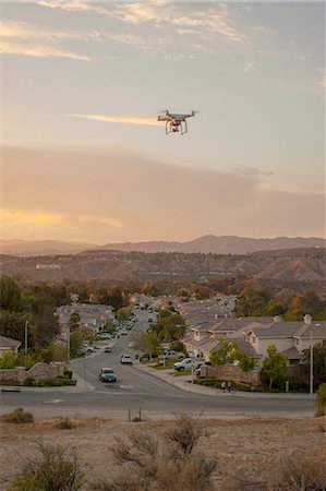security surveillance - Drone flying above housing development, Santa Clarita, California, USA Stock Photo - Premium Royalty-Free, Code: 614-08308010
