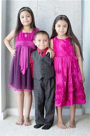 simsearch:614-08726632,k - Portrait of three siblings, wearing party clothes Fotografie stock - Premium Royalty-Free, Codice: 614-08329255