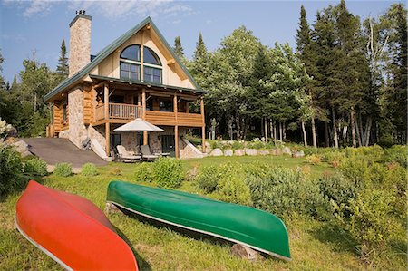 simsearch:614-08329341,k - Handcrafted spruce log home with fieldstone chimney and green metal roof in summer, Quebec, Canada Stock Photo - Premium Royalty-Free, Code: 614-08329343