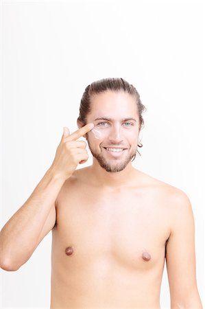simsearch:649-08060164,k - Portrait of young man applying moisturiser Stock Photo - Premium Royalty-Free, Code: 614-08329390