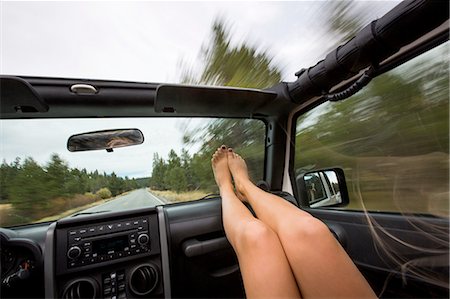 simsearch:614-03241312,k - Young woman with feet up whilst traveling in jeep Photographie de stock - Premium Libres de Droits, Code: 614-08329414