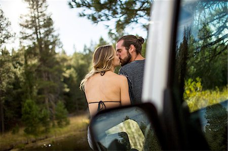 riverside - Rear view of romantic young couple kissing at riverside, Lake Tahoe, Nevada, USA Stock Photo - Premium Royalty-Free, Code: 614-08329443