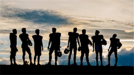 Silhouette of group of young american football players, standing in row Stock Photo - Premium Royalty-Free, Code: 614-08329466