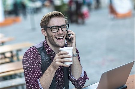 simsearch:649-08086031,k - Young businessman chatting on smartphone at sidewalk cafe Stock Photo - Premium Royalty-Free, Code: 614-08329528