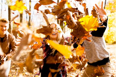 simsearch:614-06402622,k - Young woman and two teenage brothers throwing autumn leaves in forest Stock Photo - Premium Royalty-Free, Code: 614-08329538