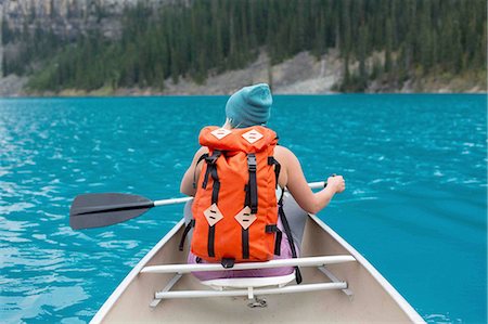 simsearch:614-08383500,k - Rear view of mid adult woman with orange colour backpack paddling canoe, Moraine lake, Banff National Park, Alberta Canada Stock Photo - Premium Royalty-Free, Code: 614-08383509