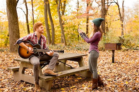 simsearch:614-08220131,k - Young woman photographing guitar playing boyfriend in autumn forest Photographie de stock - Premium Libres de Droits, Code: 614-08383598