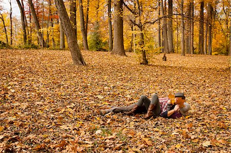 Young couple play fighting in autumn forest Stock Photo - Premium Royalty-Free, Code: 614-08383603
