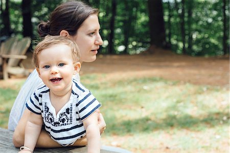 Young woman and baby daughter at forest picnic bench Stock Photo - Premium Royalty-Free, Code: 614-08383693